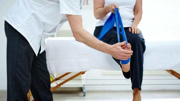 Female patient doing some special leg stretching exercises